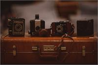 Four Vintage Cameras And A Suitcase As Framed Poster