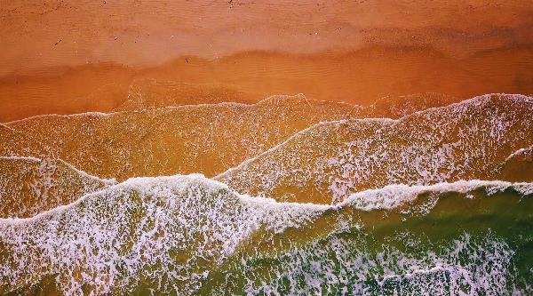 Aerial View Of Waves Crashing On A Beach